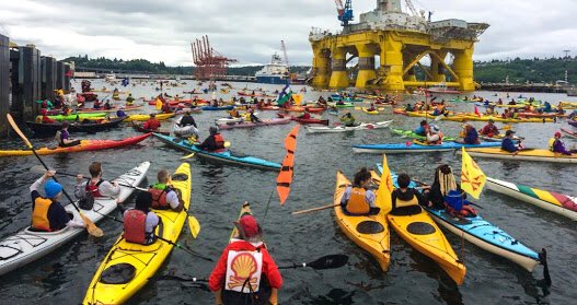 Kayaktivists protesting against oil exploration in kayaks made of oil